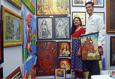 Hutoxi Wadia displays her creations with her son at the Indian Art Exhibition